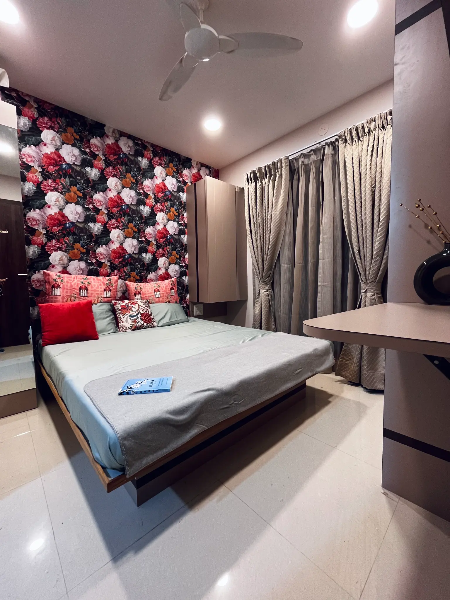 Bedroom with floral wallpaper and elegant curtains